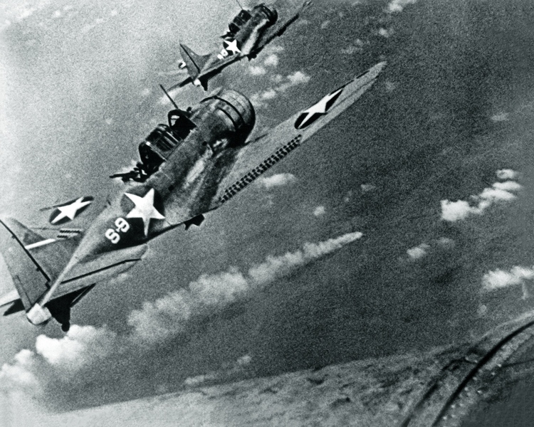 SBD-3_Dauntless_bombers_of_VS-8_over_the_burning_Japanese_cruiser_Mikuma_on_6_June_1942