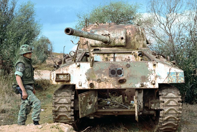 A_US_Marine_stand_near_the_rear_of_a_wrecked_Sherman_tank_in_Lebanon_1983