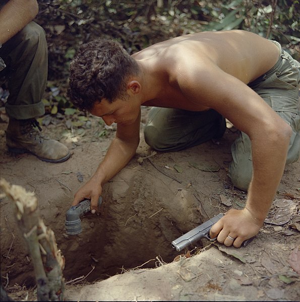 595px-NARA_111-CCV-529-CC38112_Ronald_A._Payne_checking_tunnel_entrance_Operation_Cedar_Falls_1967
